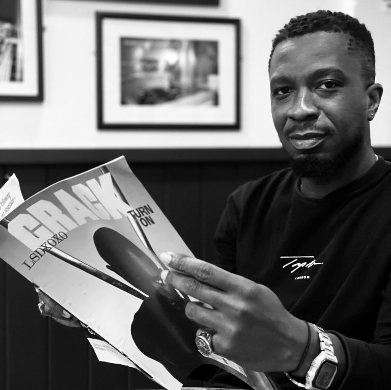 Kojo Owusu reading a magazine